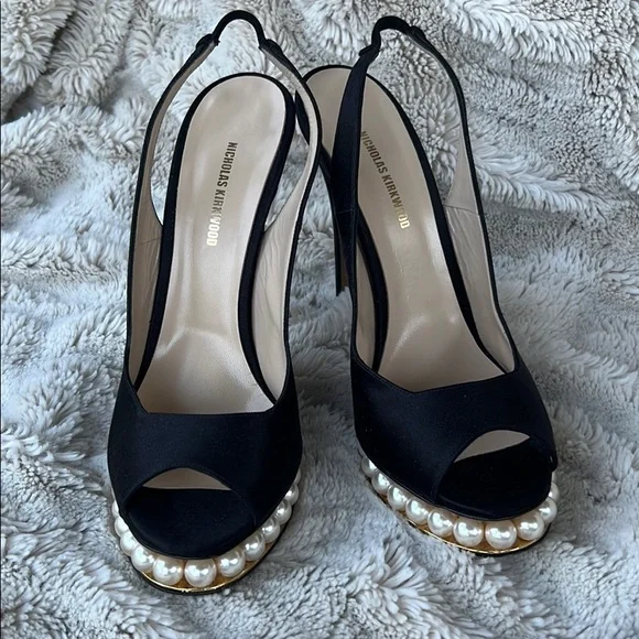 Nicholas Kirkwood black sling-back heals with signature pearl platform.
